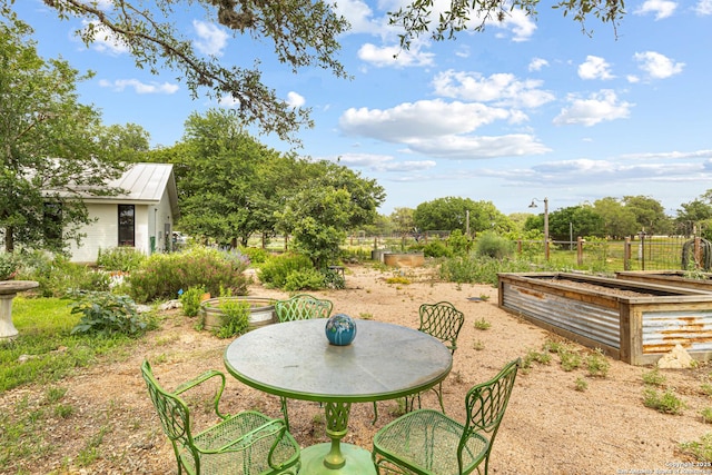 31545 Meadow Crk, Fair Oaks Ranch, TX 78015 - exterior space featuring outdoor dining space and a vegetable garden