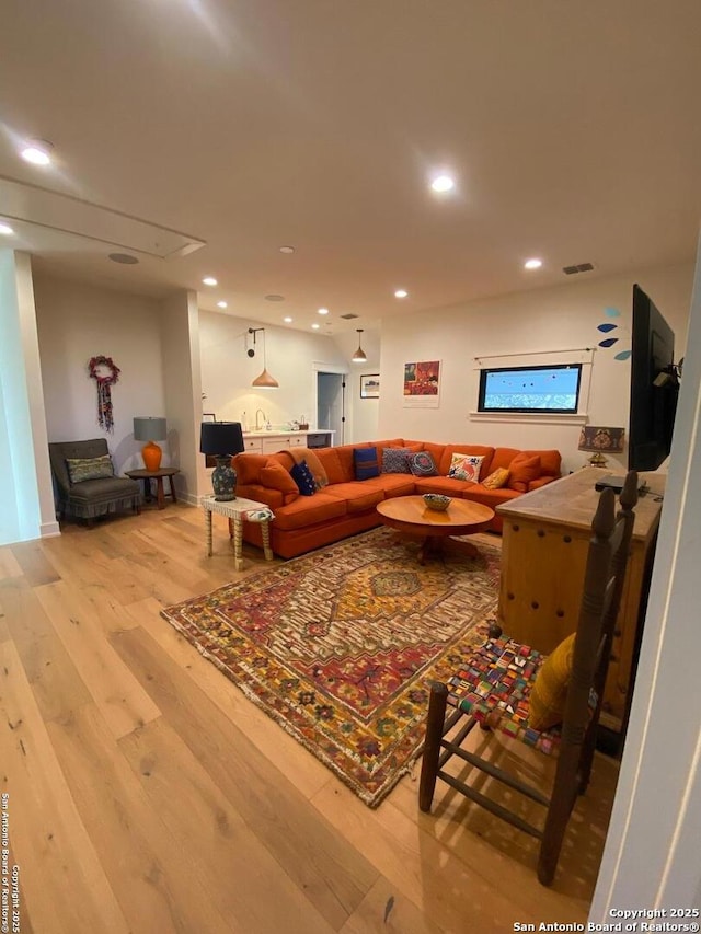 living room featuring wood finished floors, visible vents, and recessed lighting