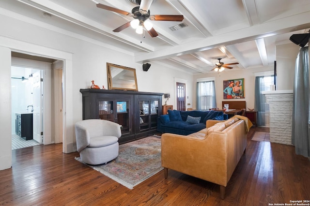 living room with beam ceiling, a fireplace, dark hardwood / wood-style floors, and ceiling fan