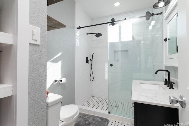 bathroom with vanity, toilet, and an enclosed shower