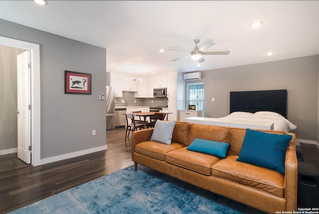 bedroom with an AC wall unit, dark hardwood / wood-style floors, and stainless steel refrigerator