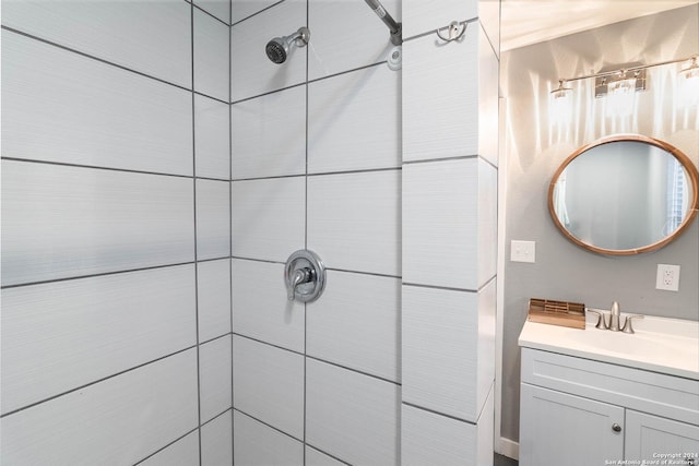 bathroom featuring vanity and tiled shower