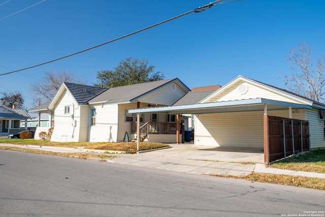 view of front of property featuring a carport and covered porch