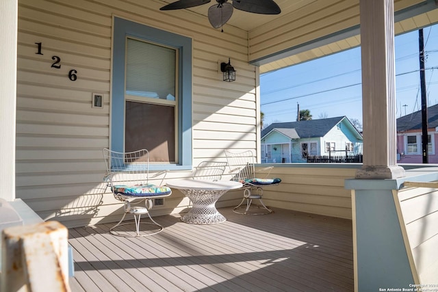 wooden deck featuring ceiling fan and covered porch