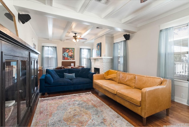 living room featuring beam ceiling, ceiling fan, a wealth of natural light, and dark hardwood / wood-style flooring