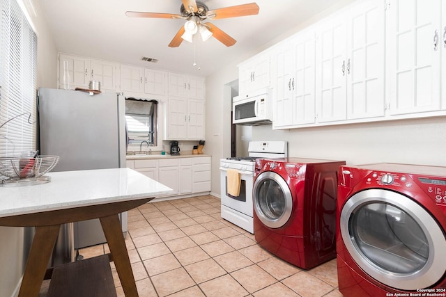 laundry room with washer and dryer, light tile patterned floors, sink, and ceiling fan