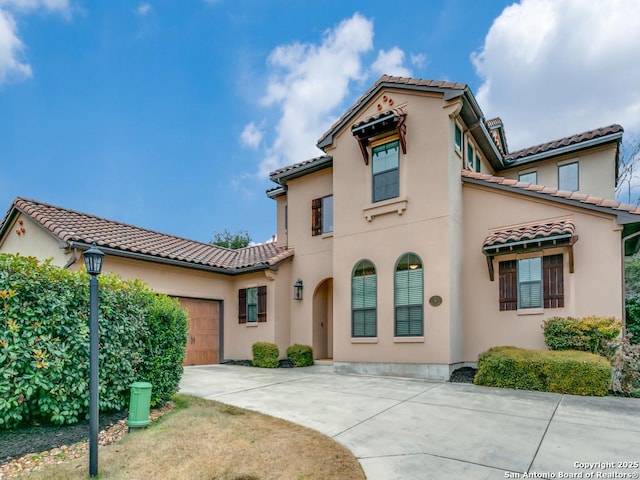 mediterranean / spanish-style house featuring a garage