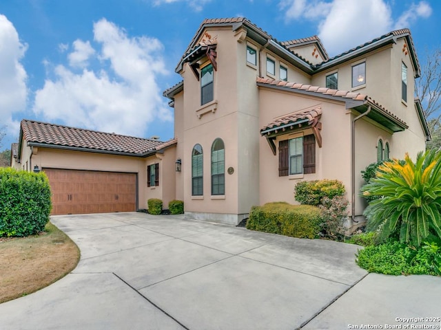 mediterranean / spanish-style house with a garage