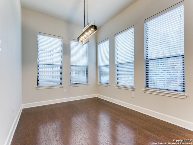 unfurnished room with dark hardwood / wood-style floors