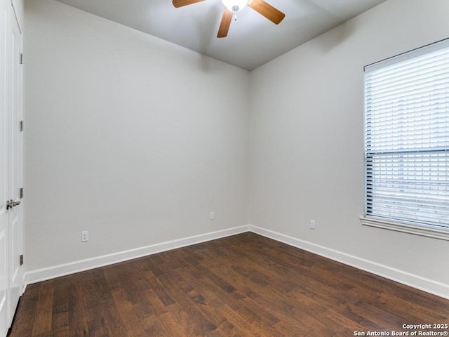 unfurnished room featuring dark wood-type flooring and ceiling fan