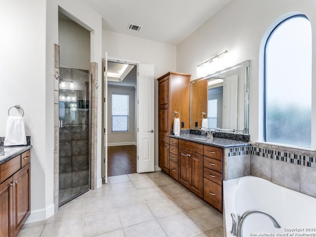 bathroom with vanity, plus walk in shower, and tile patterned flooring