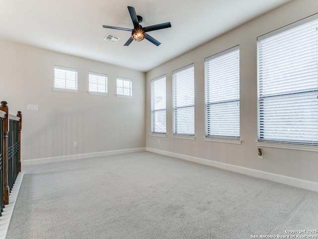 unfurnished room featuring ceiling fan and light carpet