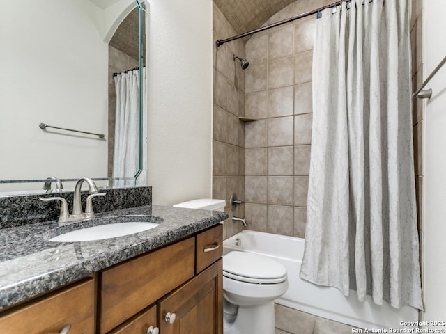 full bathroom featuring shower / bathtub combination with curtain, vanity, tile patterned floors, and toilet