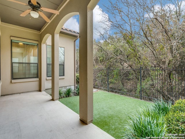 view of yard featuring ceiling fan and a patio area