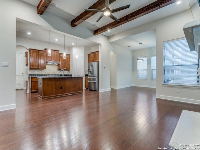 unfurnished living room with dark hardwood / wood-style flooring, sink, beamed ceiling, and ceiling fan