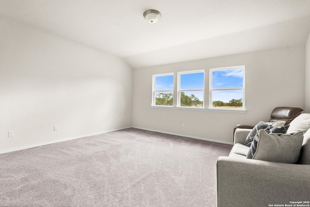 sitting room featuring lofted ceiling and carpet floors