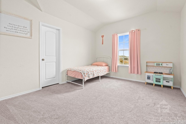 bedroom with vaulted ceiling and carpet