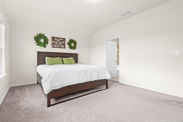 carpeted bedroom with lofted ceiling