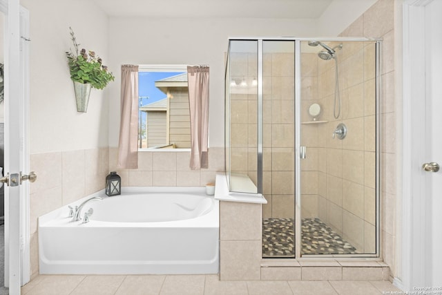 bathroom featuring tile patterned flooring and separate shower and tub