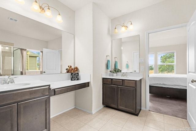 bathroom featuring tile patterned flooring, vanity, and an enclosed shower