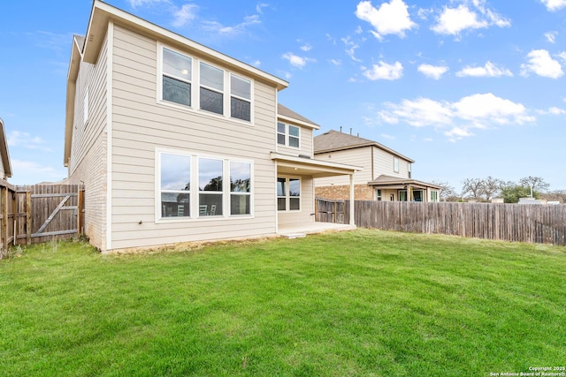 back of house with a yard and a patio area