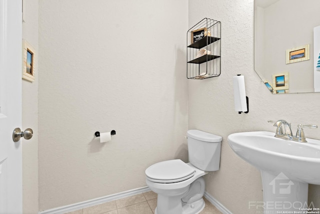 bathroom with tile patterned floors, toilet, and sink