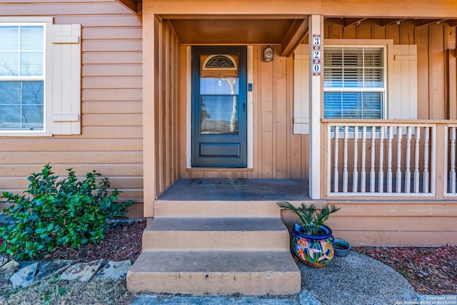 doorway to property featuring covered porch