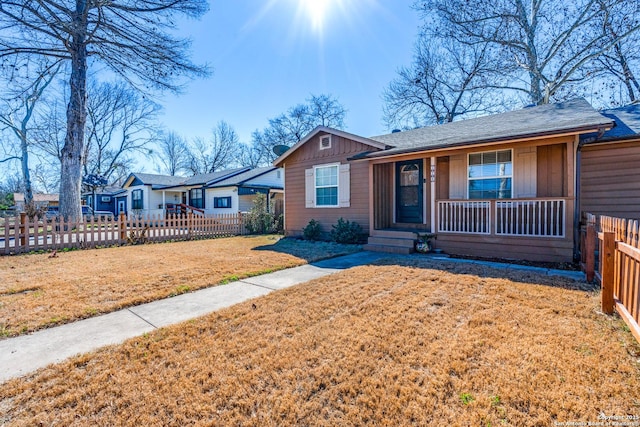 ranch-style home with a front yard and a porch