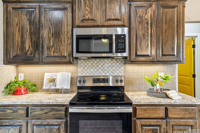 kitchen with stainless steel appliances, tasteful backsplash, and dark brown cabinetry