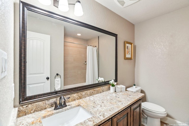 bathroom featuring vanity, toilet, and a shower with shower curtain