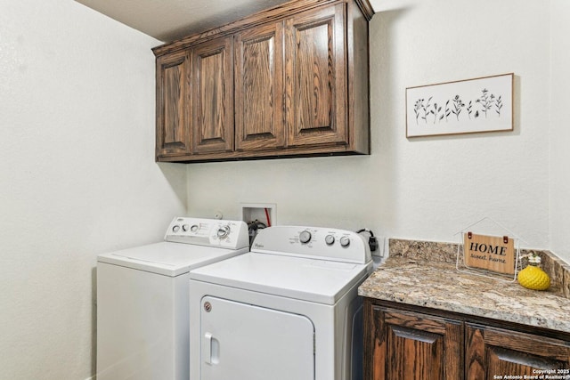 washroom with washing machine and dryer and cabinets