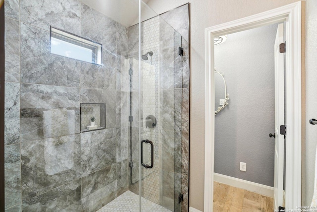 bathroom featuring hardwood / wood-style floors and walk in shower