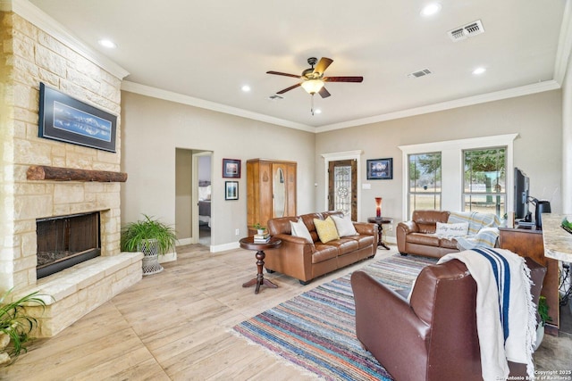 living room featuring ornamental molding, ceiling fan, a fireplace, and light hardwood / wood-style flooring