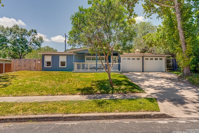 single story home featuring a porch, a garage, and a front lawn