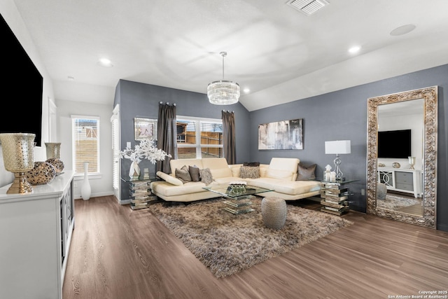 living room featuring lofted ceiling, plenty of natural light, and wood-type flooring