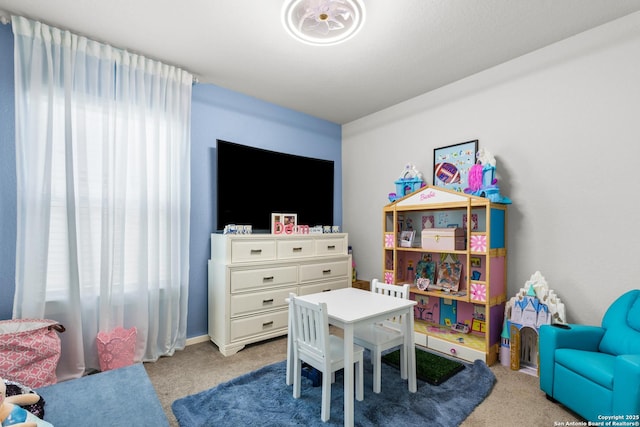 recreation room with light carpet