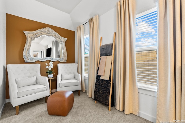 living area with lofted ceiling and light colored carpet