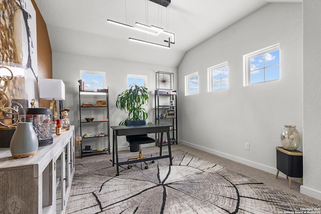 carpeted office space featuring vaulted ceiling