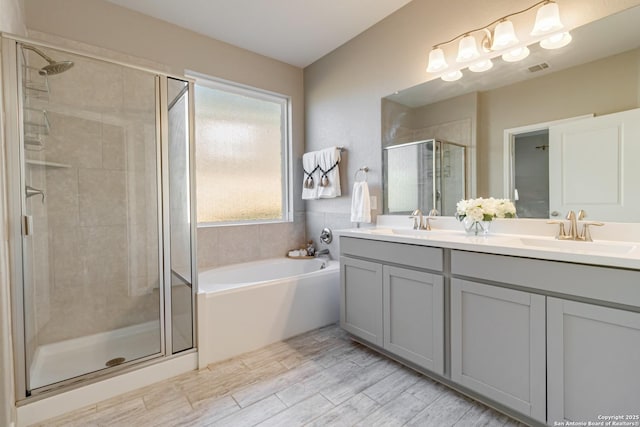 bathroom with plus walk in shower and vanity