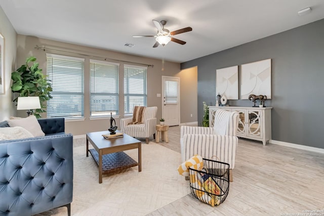 living room featuring ceiling fan and light hardwood / wood-style floors