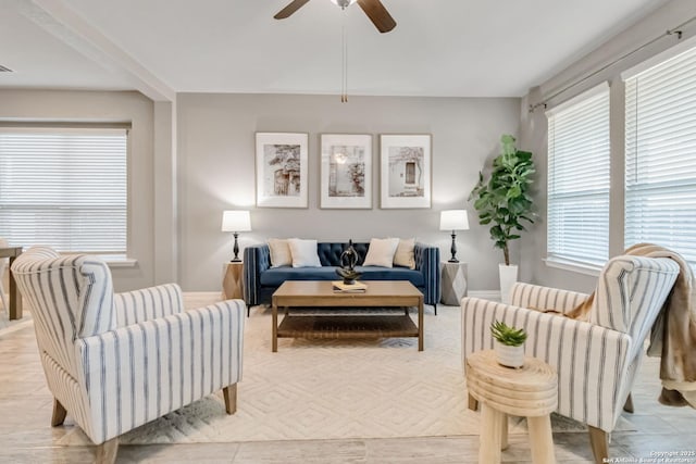 living room featuring light tile patterned floors and ceiling fan