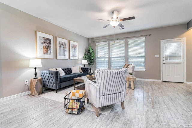 living room with ceiling fan and light hardwood / wood-style floors