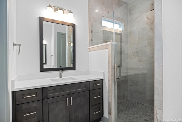 bathroom featuring an enclosed shower and vanity