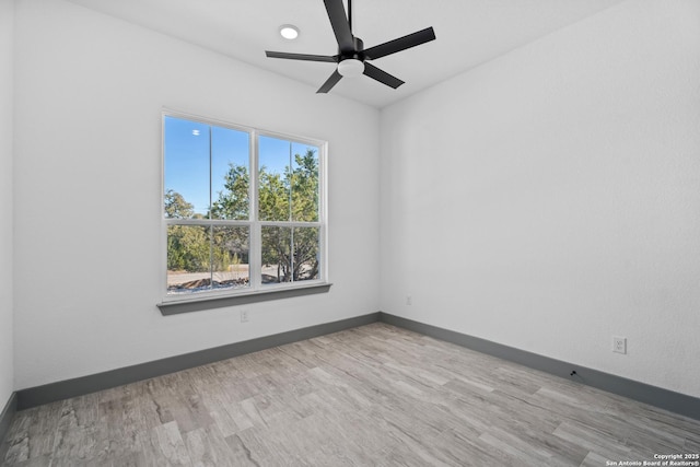 unfurnished room featuring ceiling fan and light wood-type flooring