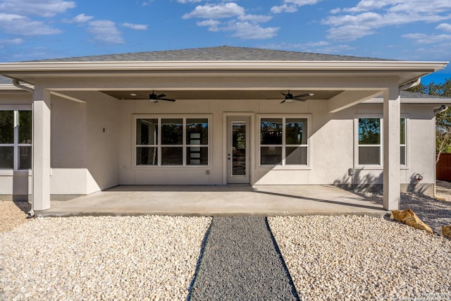 rear view of house featuring ceiling fan and a patio