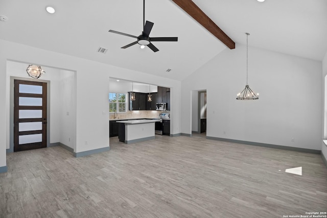 unfurnished living room featuring high vaulted ceiling, ceiling fan with notable chandelier, beam ceiling, and light hardwood / wood-style flooring