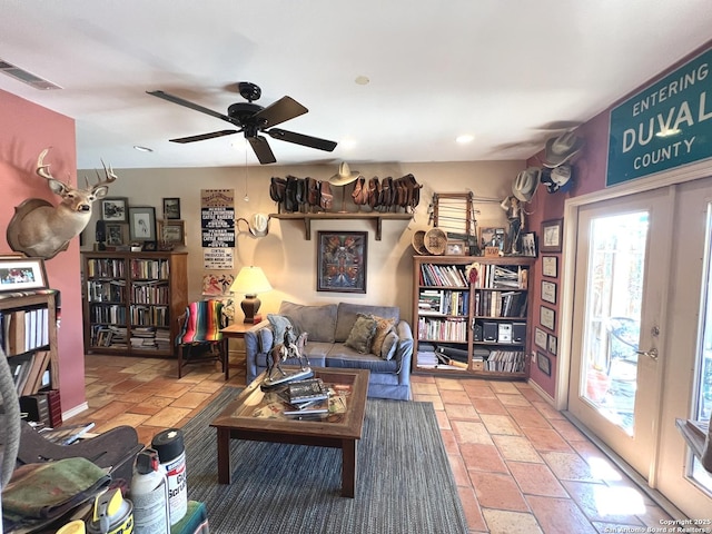 living room featuring french doors and ceiling fan