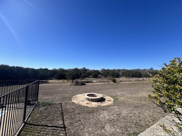 view of yard with a rural view and an outdoor fire pit