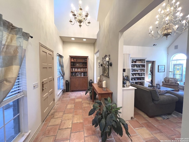 hallway with a notable chandelier and high vaulted ceiling