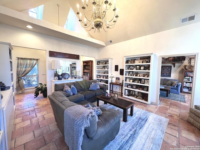 living room featuring a chandelier and high vaulted ceiling